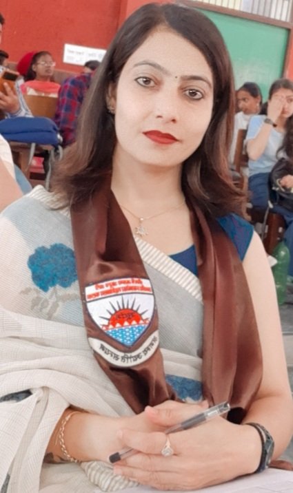 Portrait of Dr. Kapoor wearing traditional attire with academic books in background